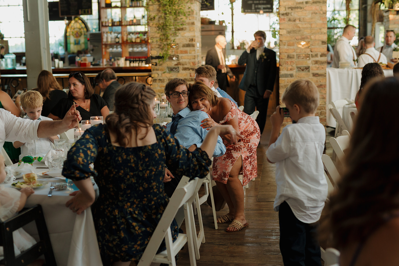 Guests sitting at tables mingling and celebrating at Milwaukee wedding venue reception