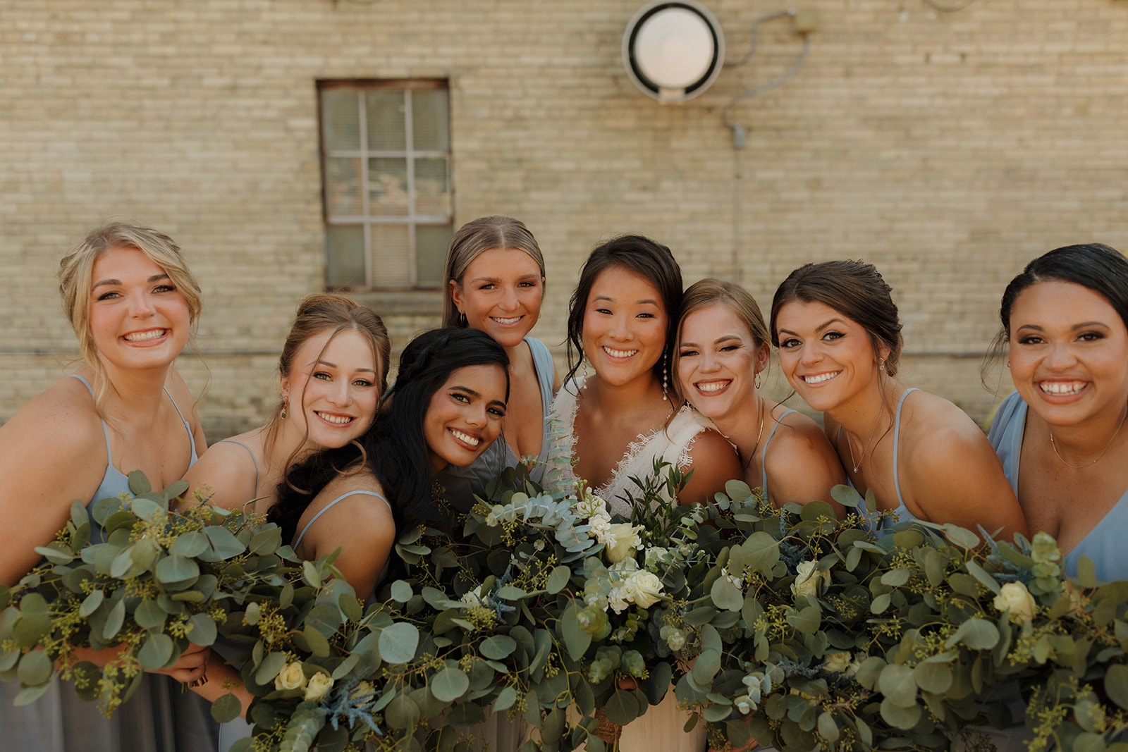 Bride surrounded by her bridesmaids celebrating her recent marriage 