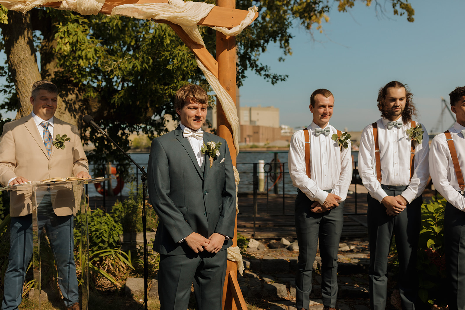 Groom stands at alter and ceremony spot watching his bride walk down the aisle