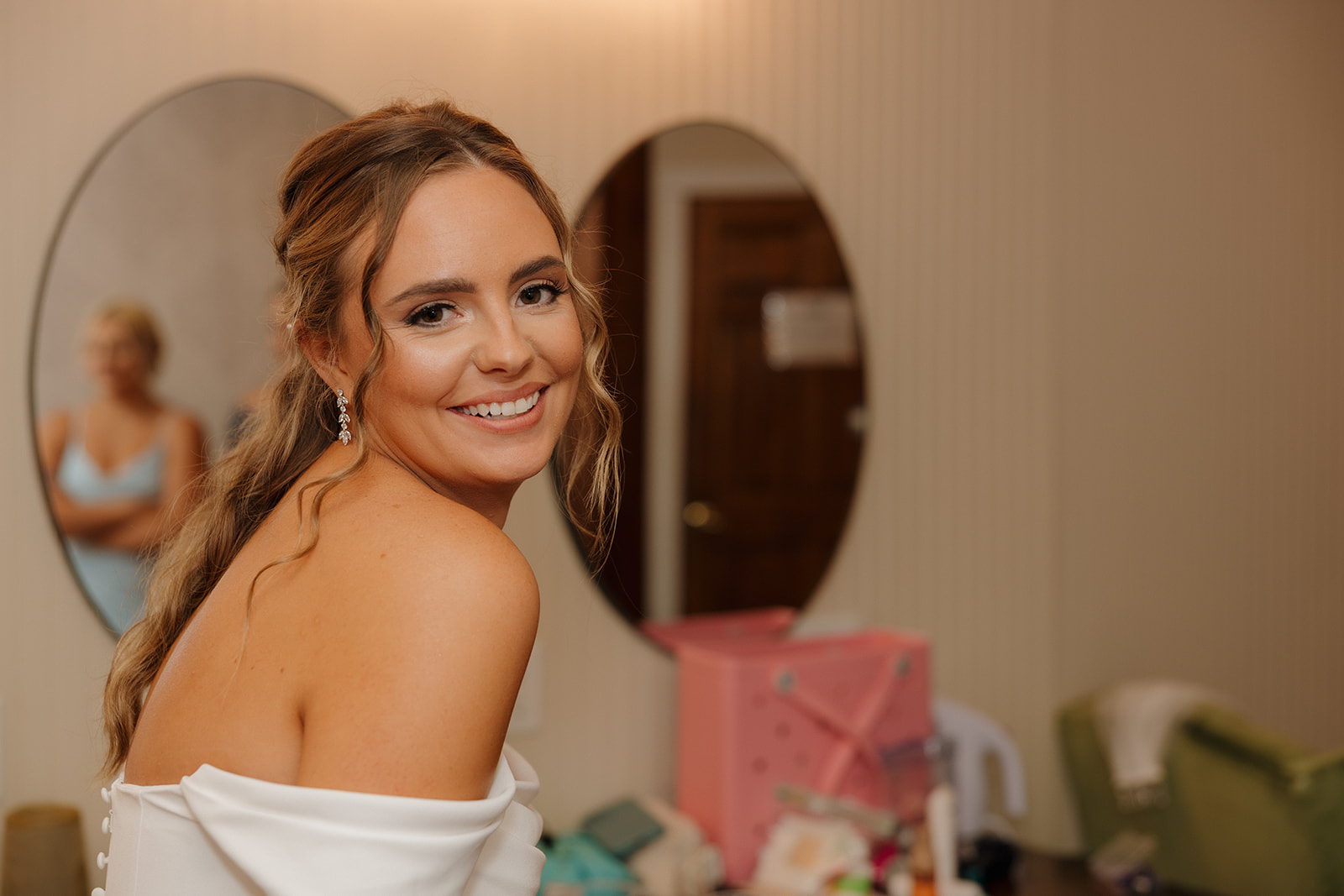 Bride smiling while getting ready in the bridal suite at a Wisconsin wedding venue.
