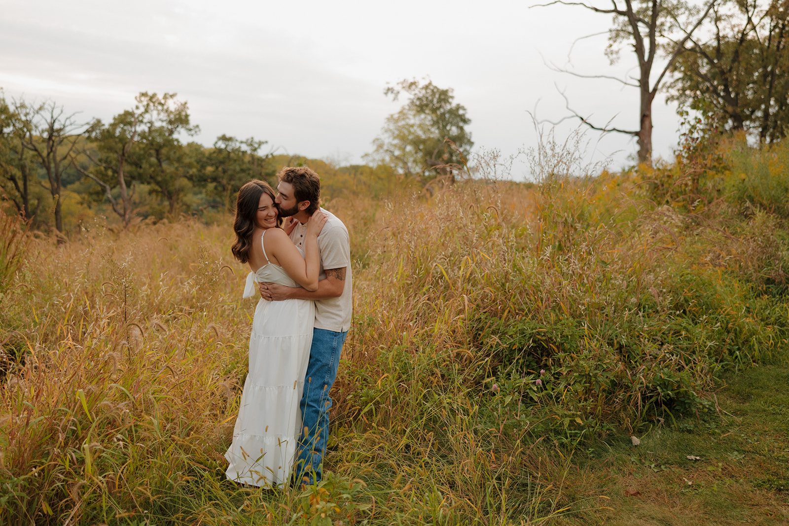 Couple dancing slowly in a wildflower field near Madison WI, soaking in the sunset.