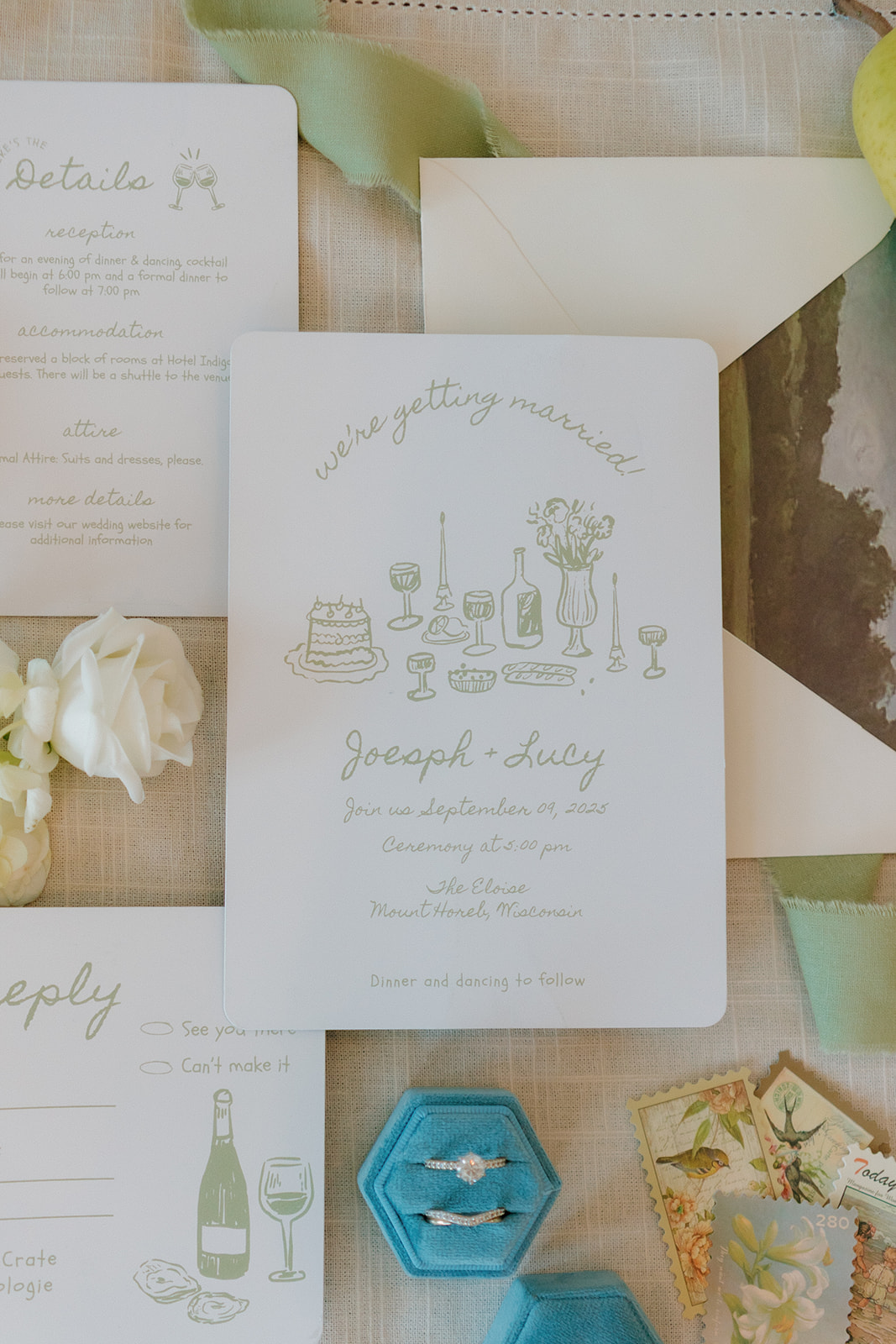 Flat lay of wedding invitations with hand-drawn details, velvet ring box, and heirloom touches—elevated paper goods for thoughtful weddings in Wisconsin.