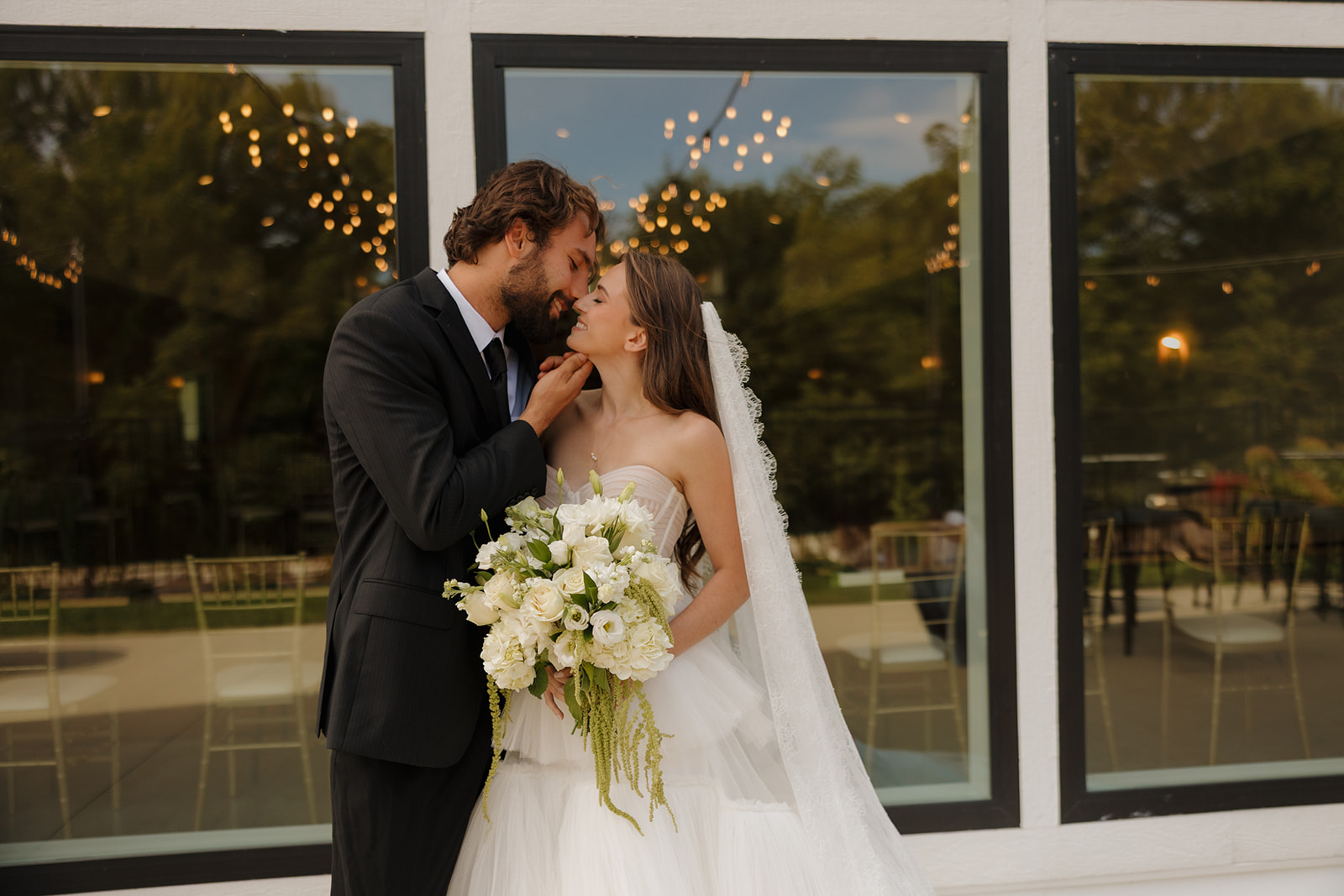 Golden hour glow and classic black-and-white attire meet in this sunlit shot of the couple walking away into their next chapter.