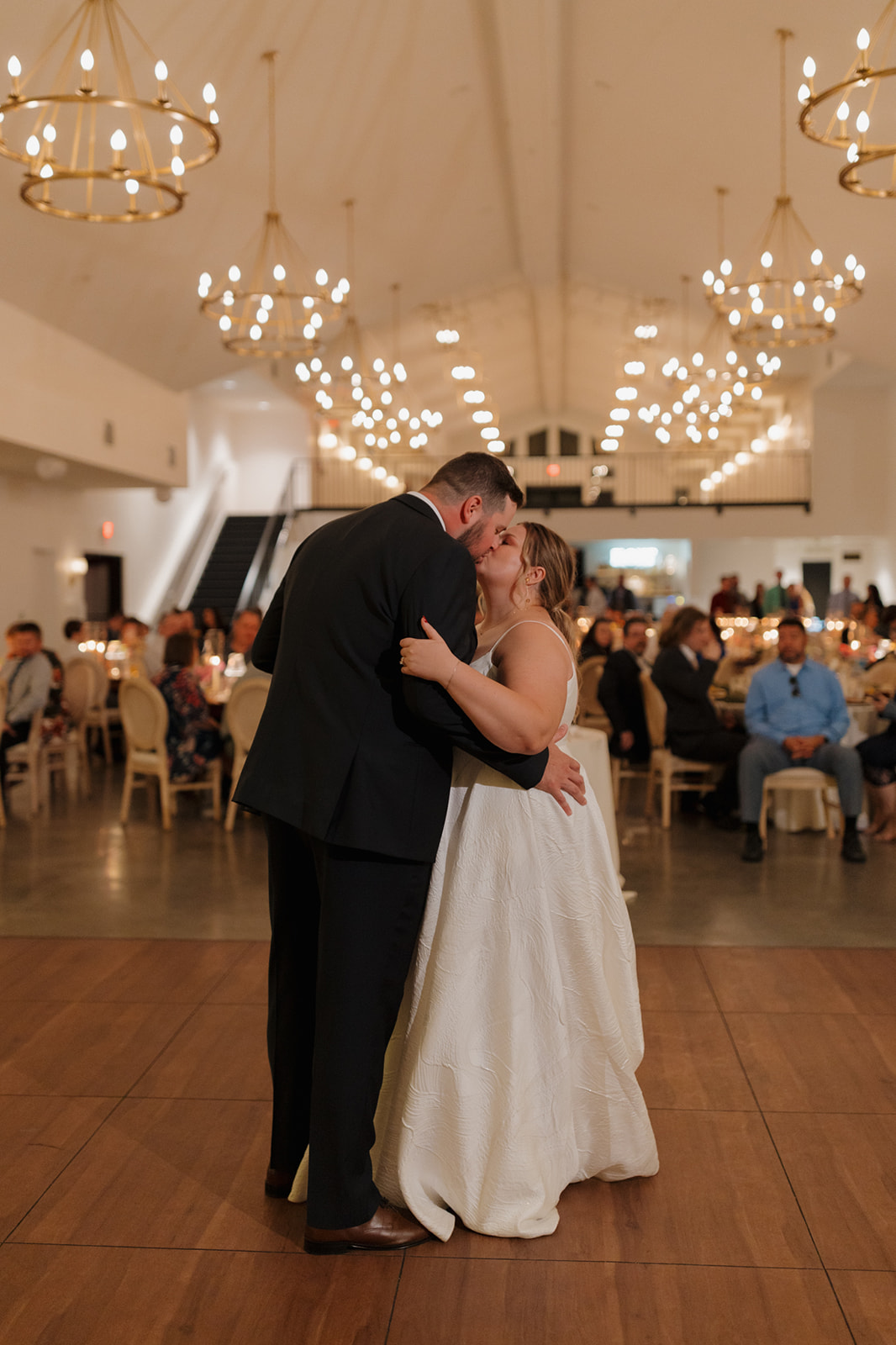 Couple kisses during their first dance at a romantic wedding reception in Wisconsin.