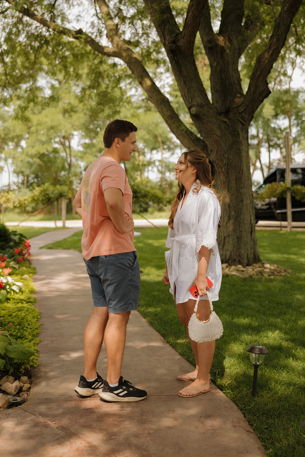 A candid pre-ceremony moment with the couple in casual attire, soaking in a quiet breath together before the big reveal.