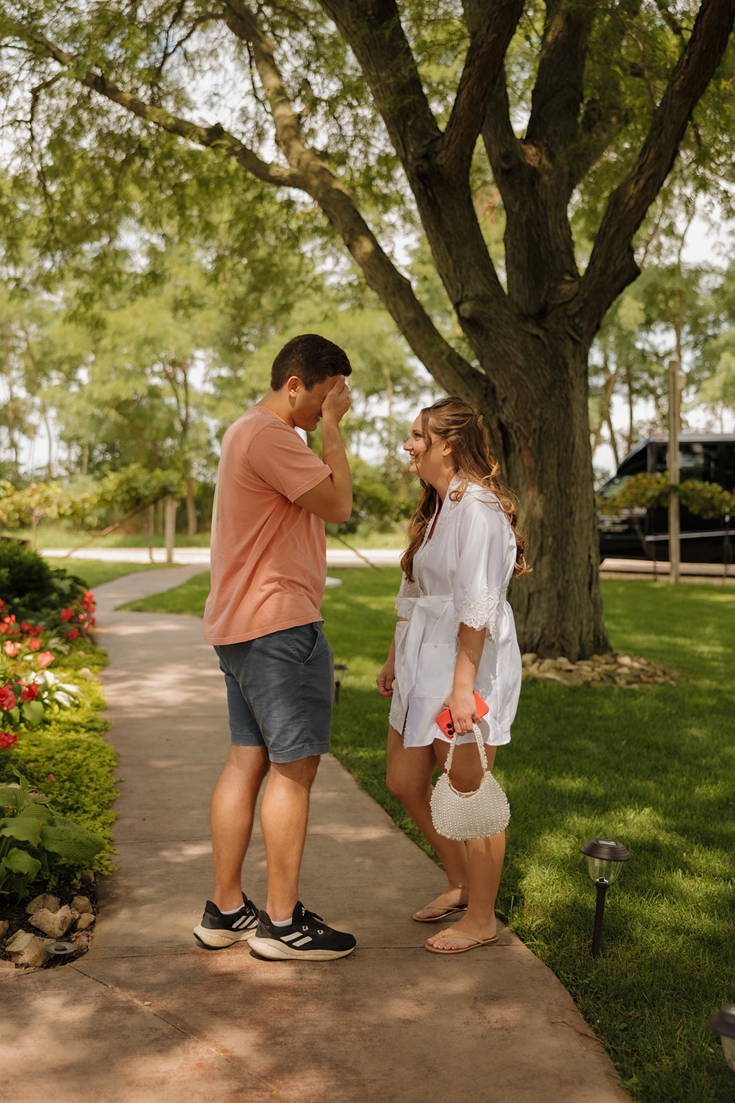 A quiet, heartfelt moment between the couple before the ceremony—barefoot bride, soft smiles, and a breath of calm.