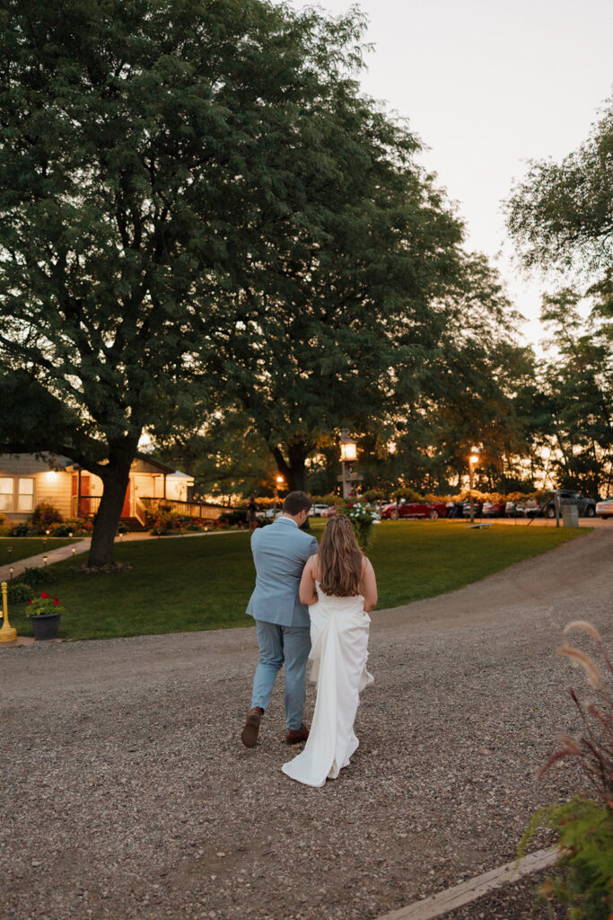 Golden hour stroll down a gravel path—proof that Madison wedding venues shine in every soft sunset moment.