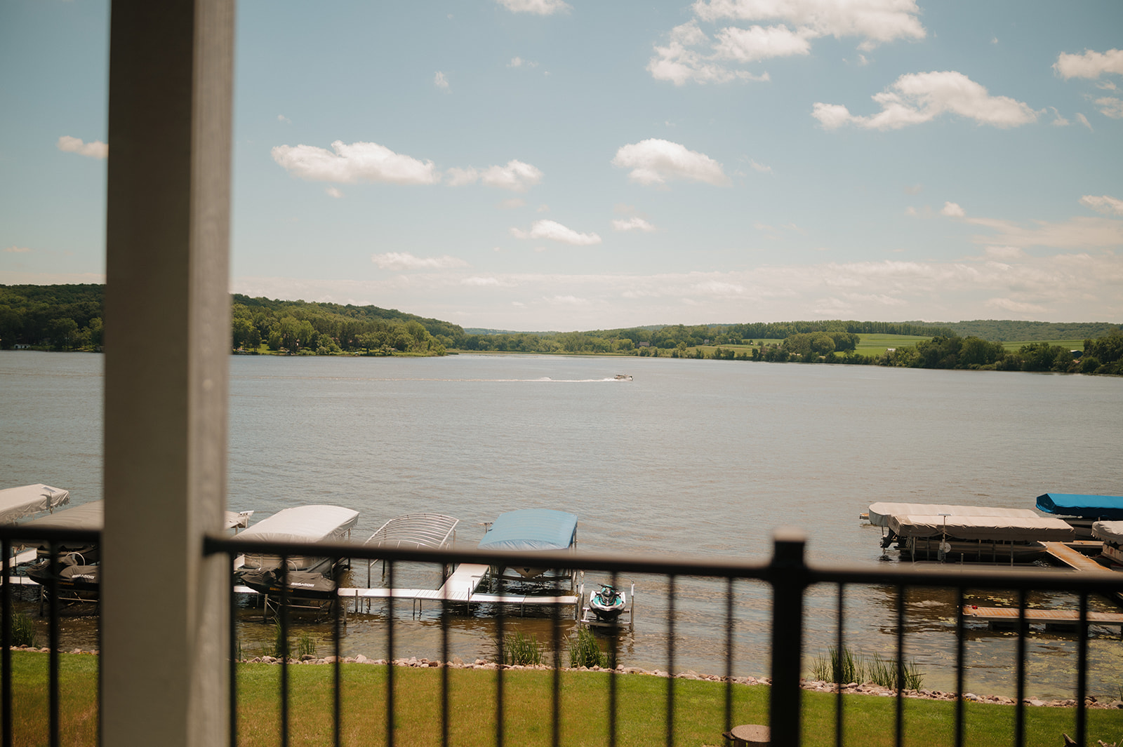 Peaceful waterfront view with docks and boats on a sunny summer day in Wisconsin.