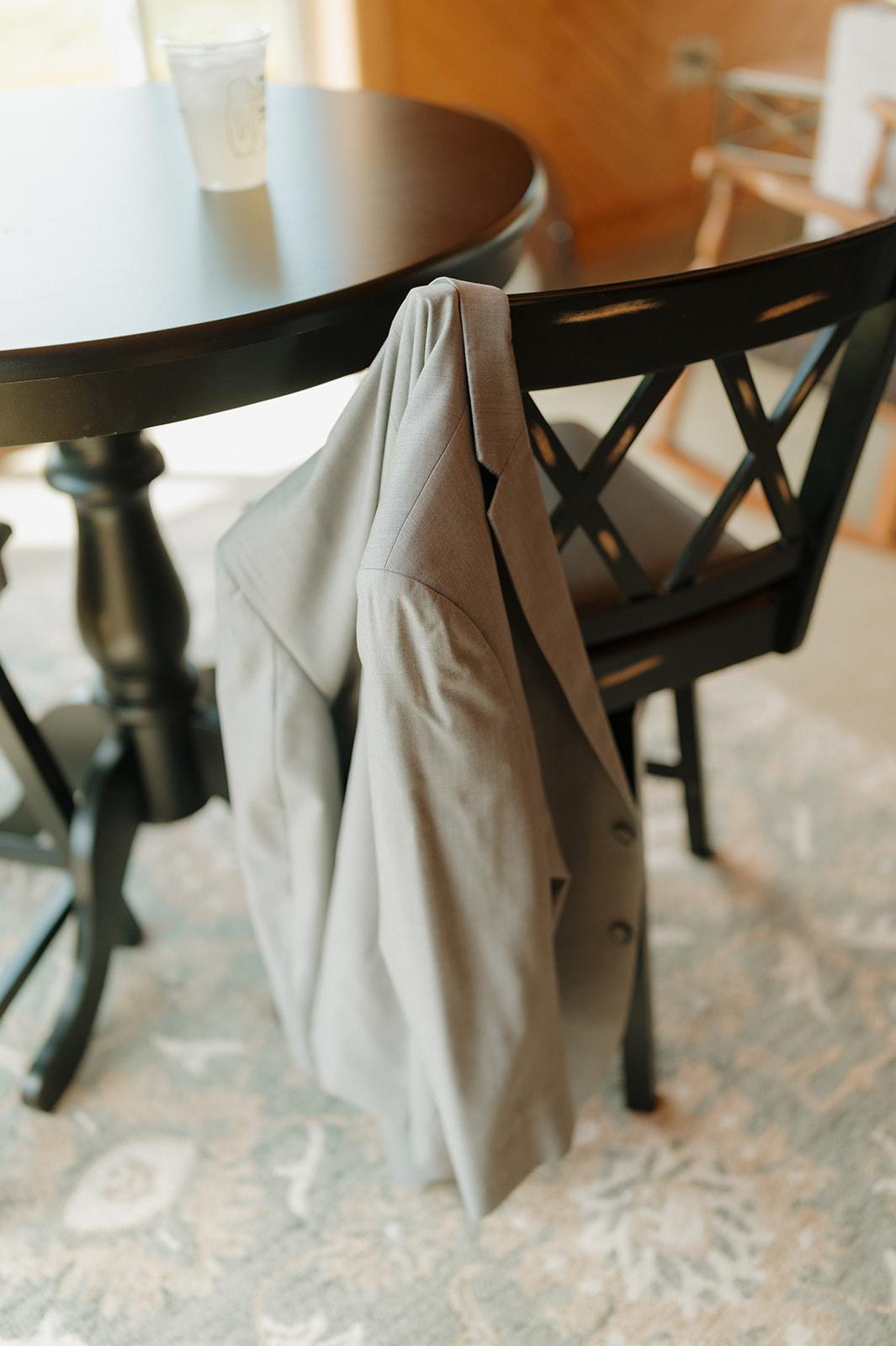 A quiet moment captured — groom’s suit jacket resting on a chair before the wedding festivities.