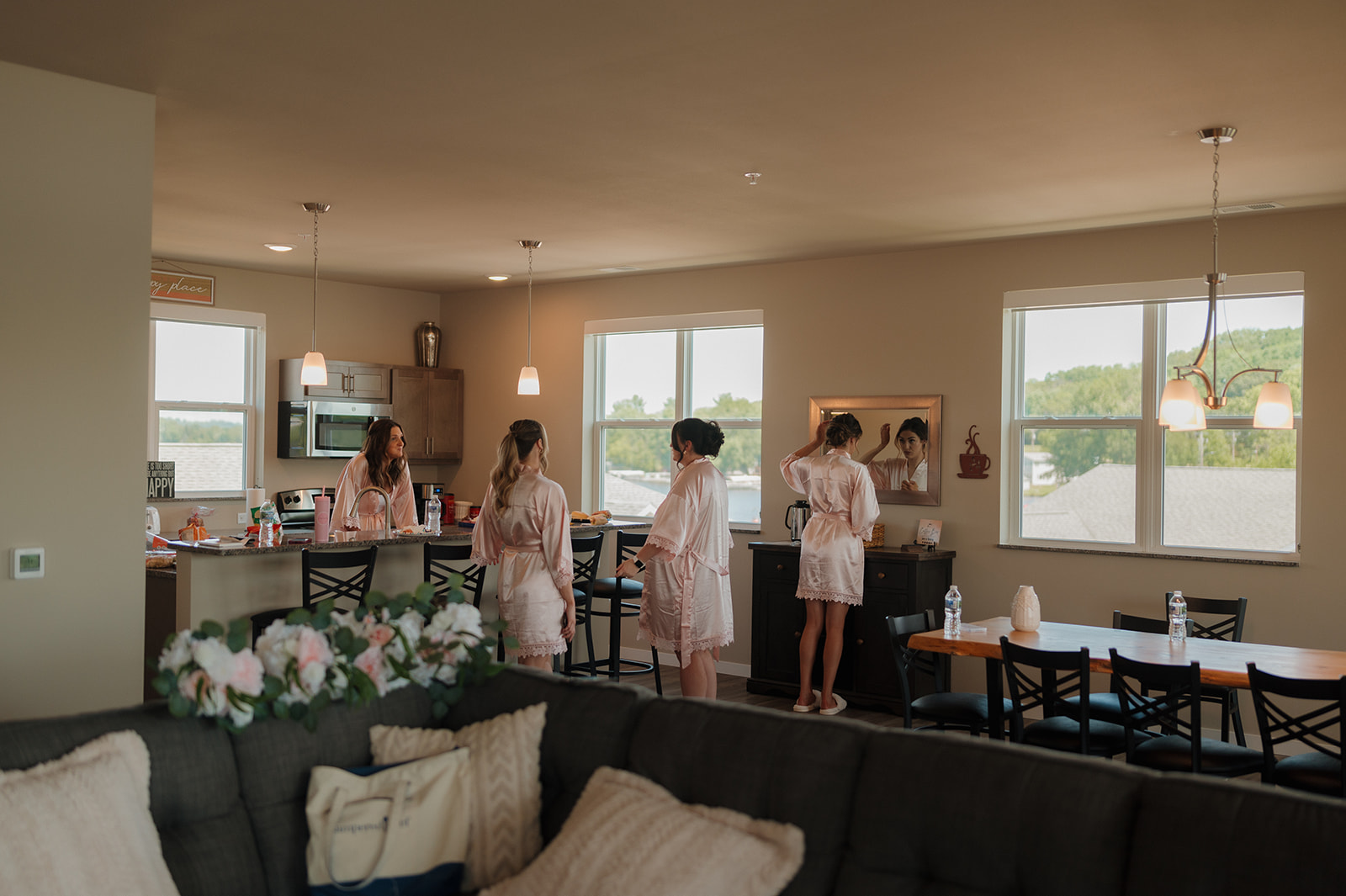 Bridesmaids in soft robes gather and get ready for a vineyard ceremony.