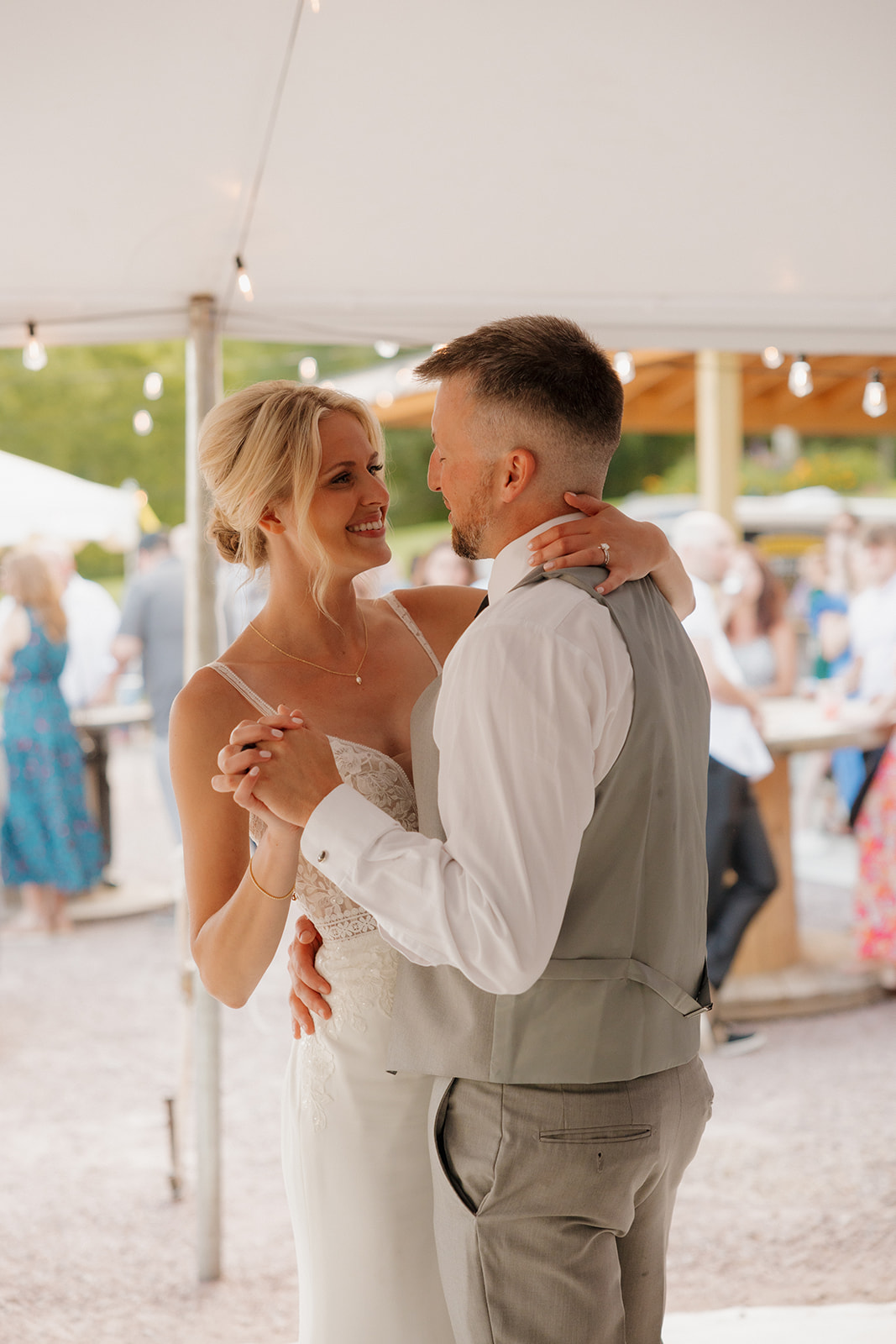 Bride and groom smiling during their first dance at their Wisconsin winery wedding venue.
