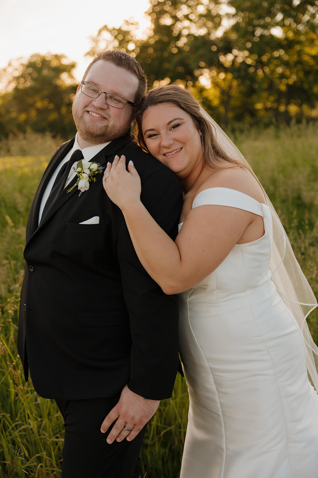 Newlyweds smiling during golden hour portraits at wedding venues in Wisconsin