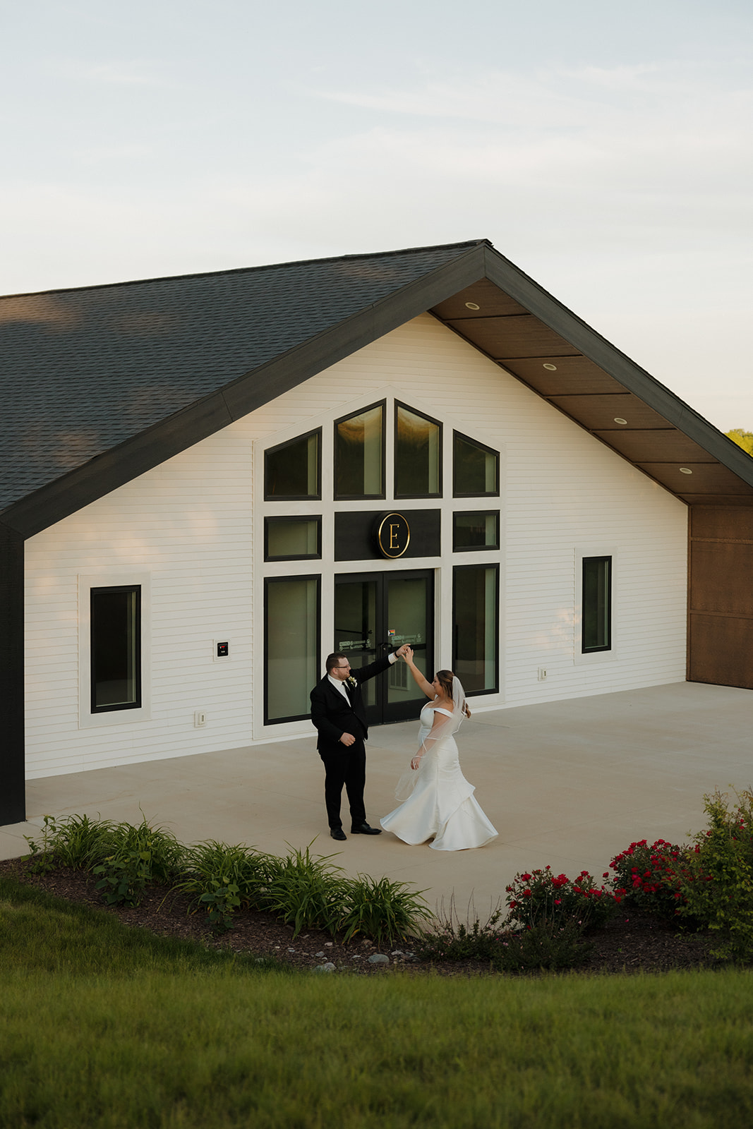 Bride and groom twirling outside modern wedding venues in Wisconsin