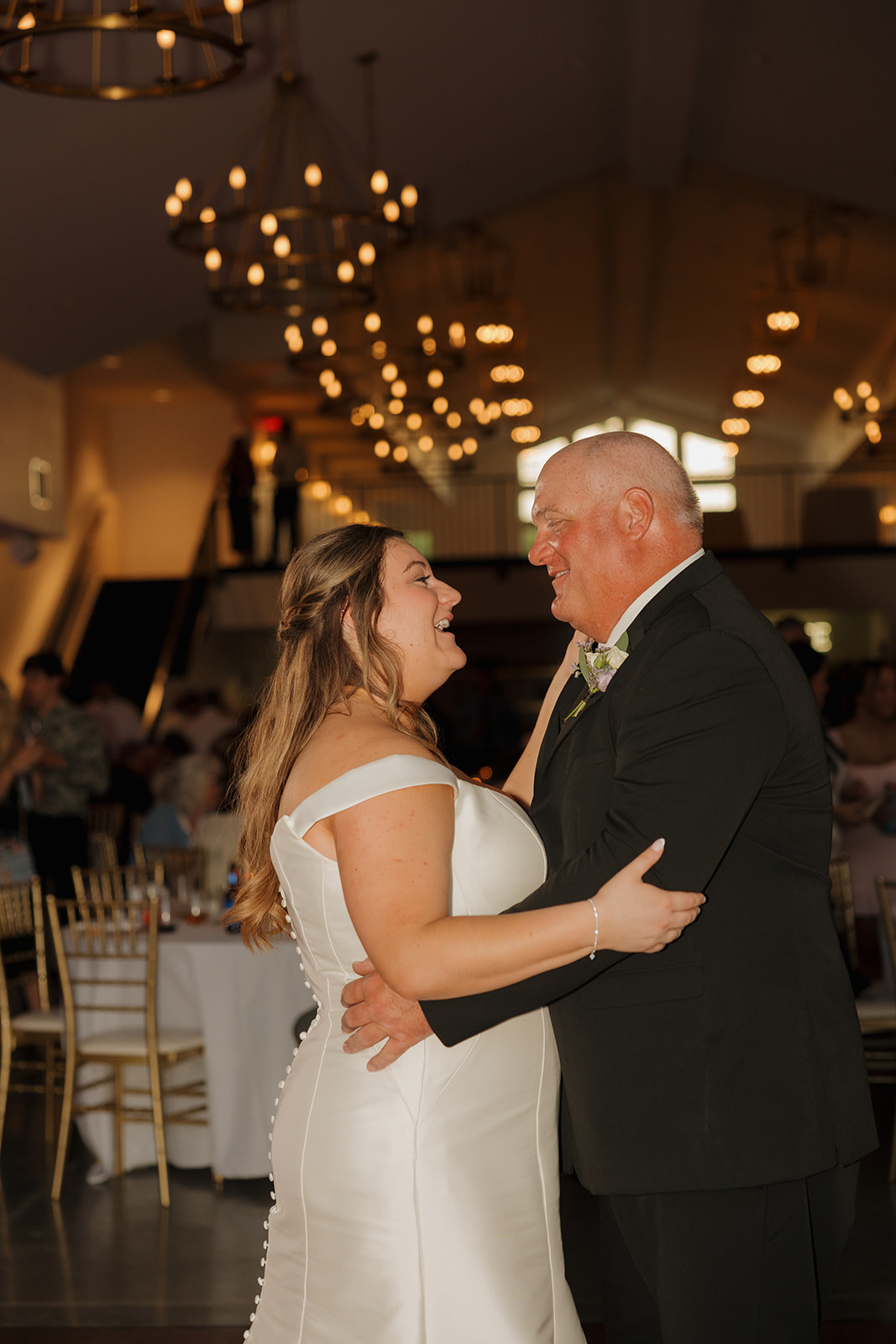 Father and bride dancing during reception