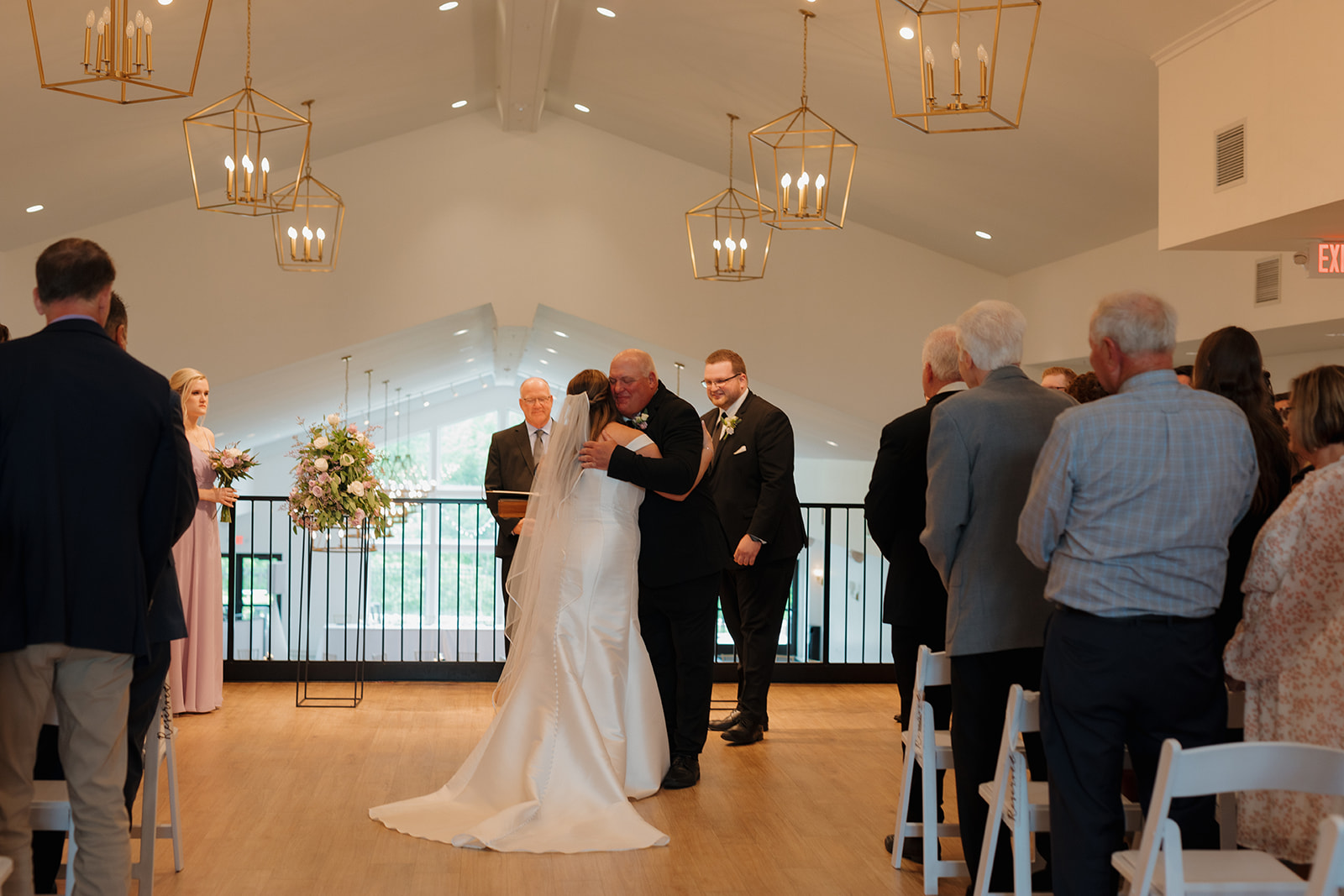 Bride hugging her father during ceremony at modern wedding venues in Wisconsin