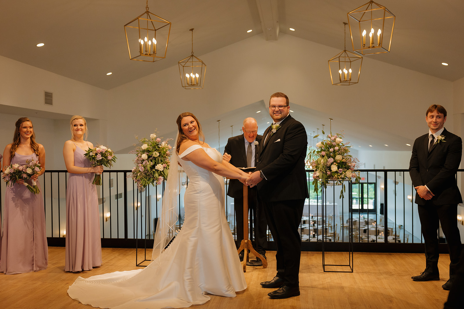 Bride and groom holding hands during ceremony at wedding venues in Wisconsin