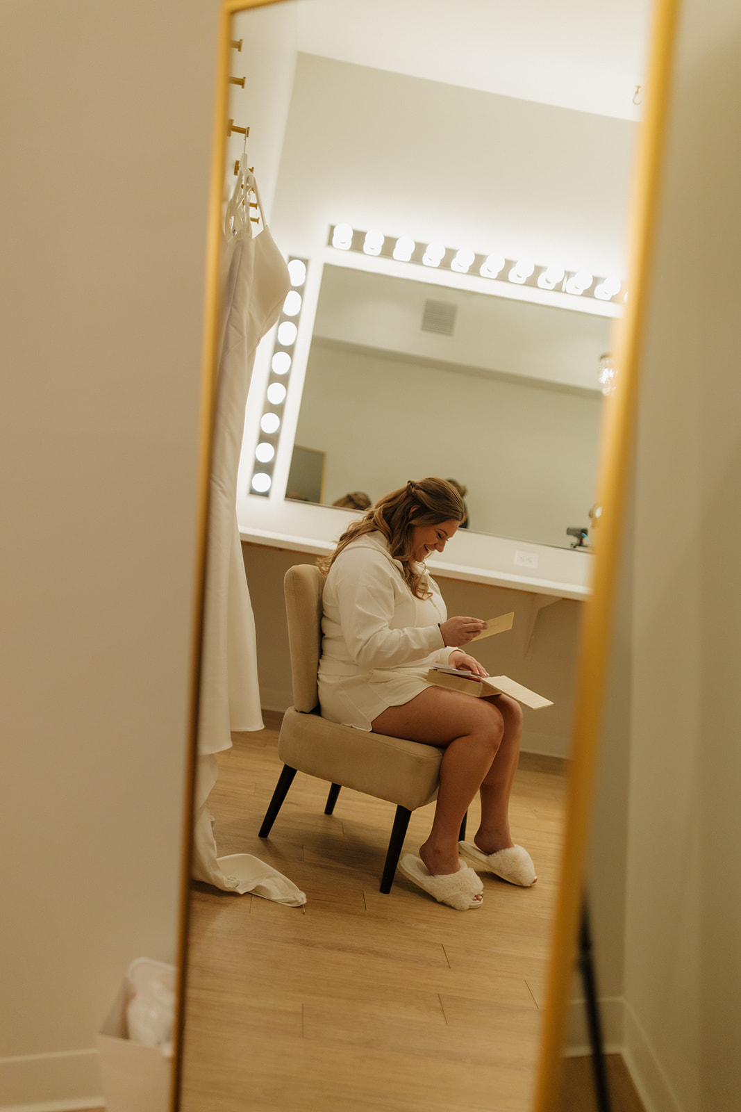Bride reading a letter in a modern bridal suite at wedding venues in Wisconsin