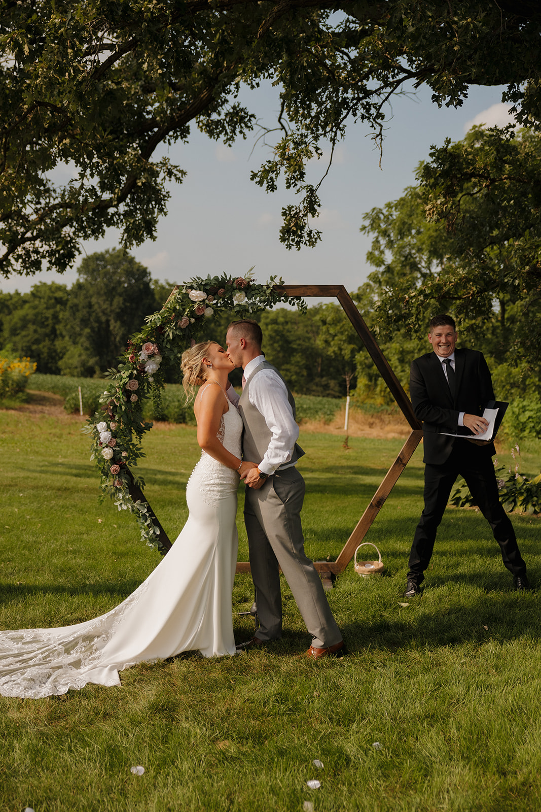 The kiss! Couple shares their first smooch as newlyweds—an iconic wedding photography checklist moment.