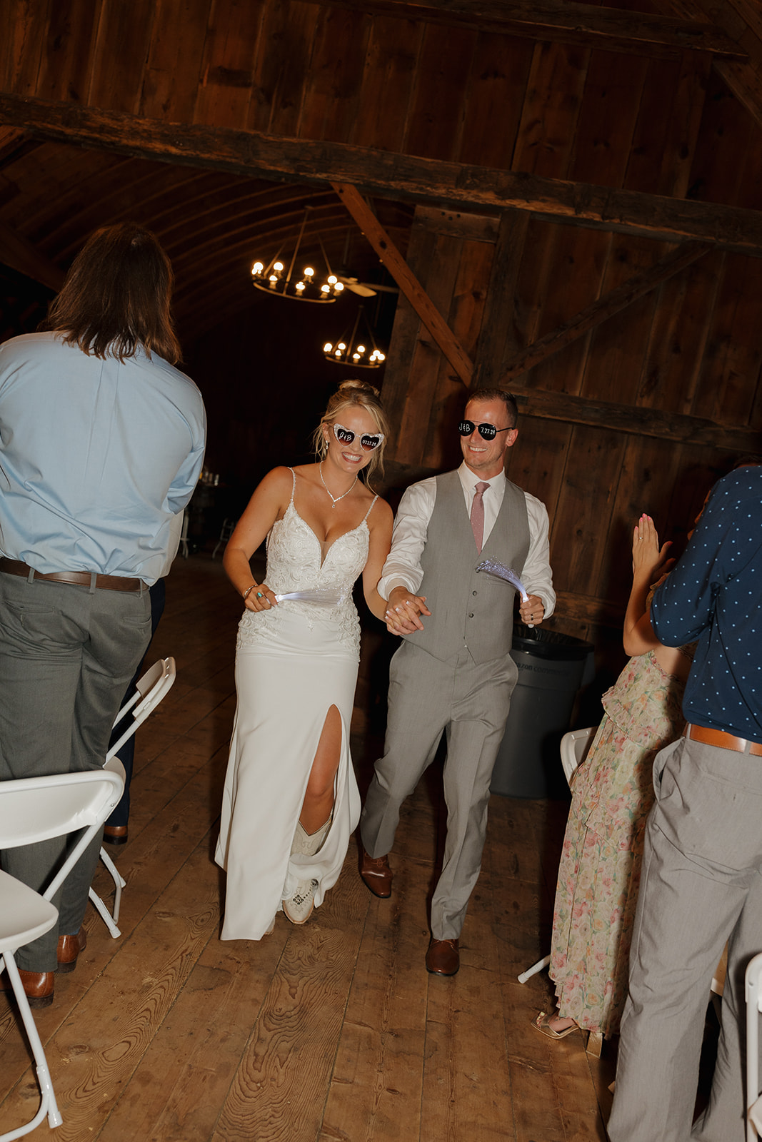 The couple enters the reception with sunglasses and style—fun entrances are must-haves on the wedding photography checklist.