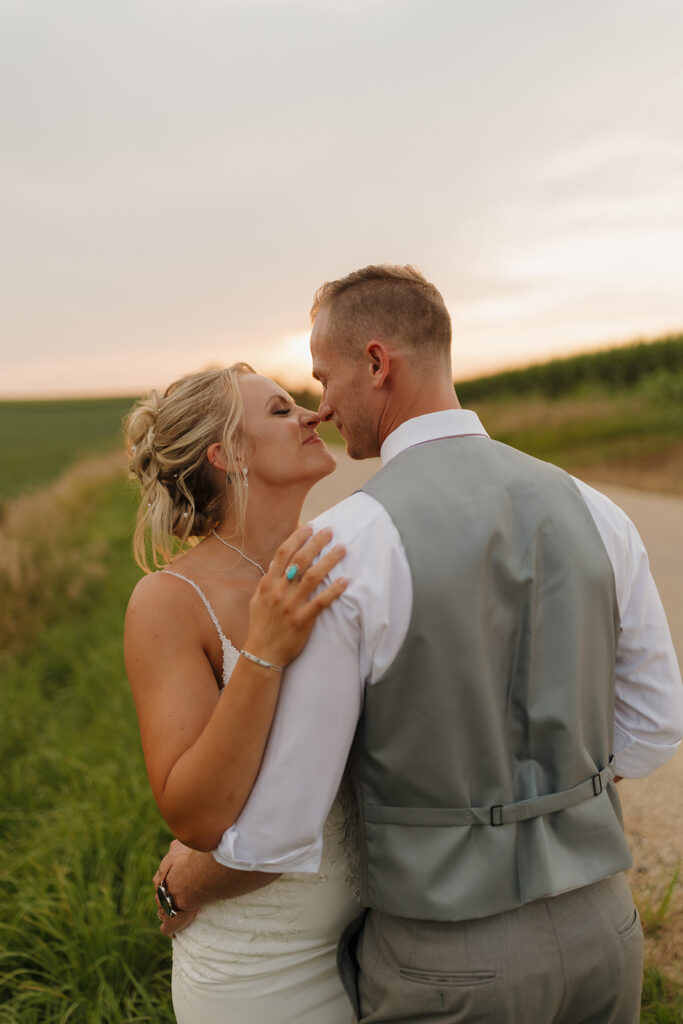 Couple sharing a quiet embrace at sunset in a Wisconsin field.