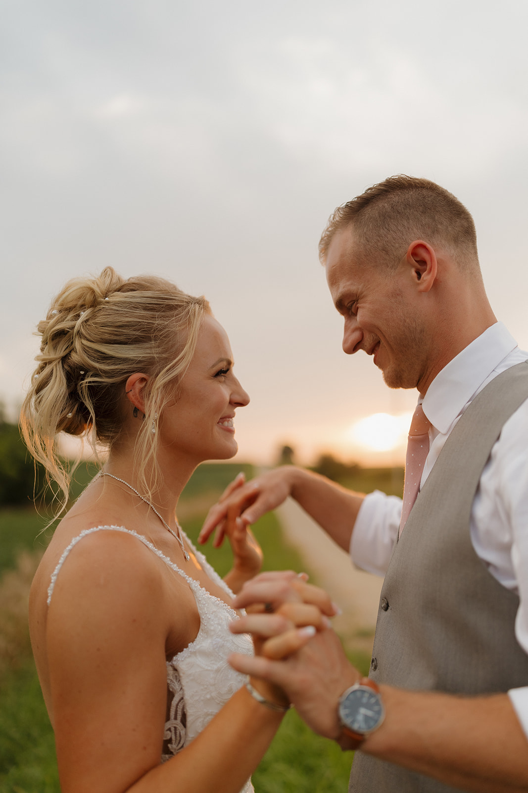 Close-up of the couple holding hands and smiling at golden hour—perfect for your wedding photography checklist.