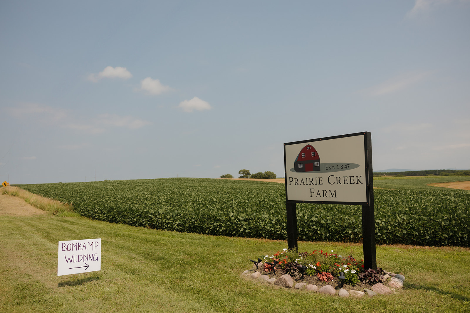 Welcome sign for a Prairie Creek Farm wedding in Wisconsin countryside.