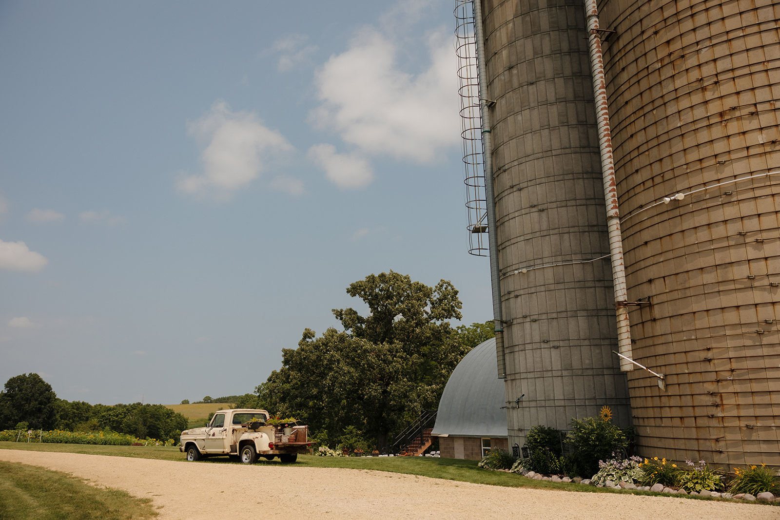Rustic silo and vintage truck at Prairie Creek Farm—setting the scene for a rural Wisconsin wedding.