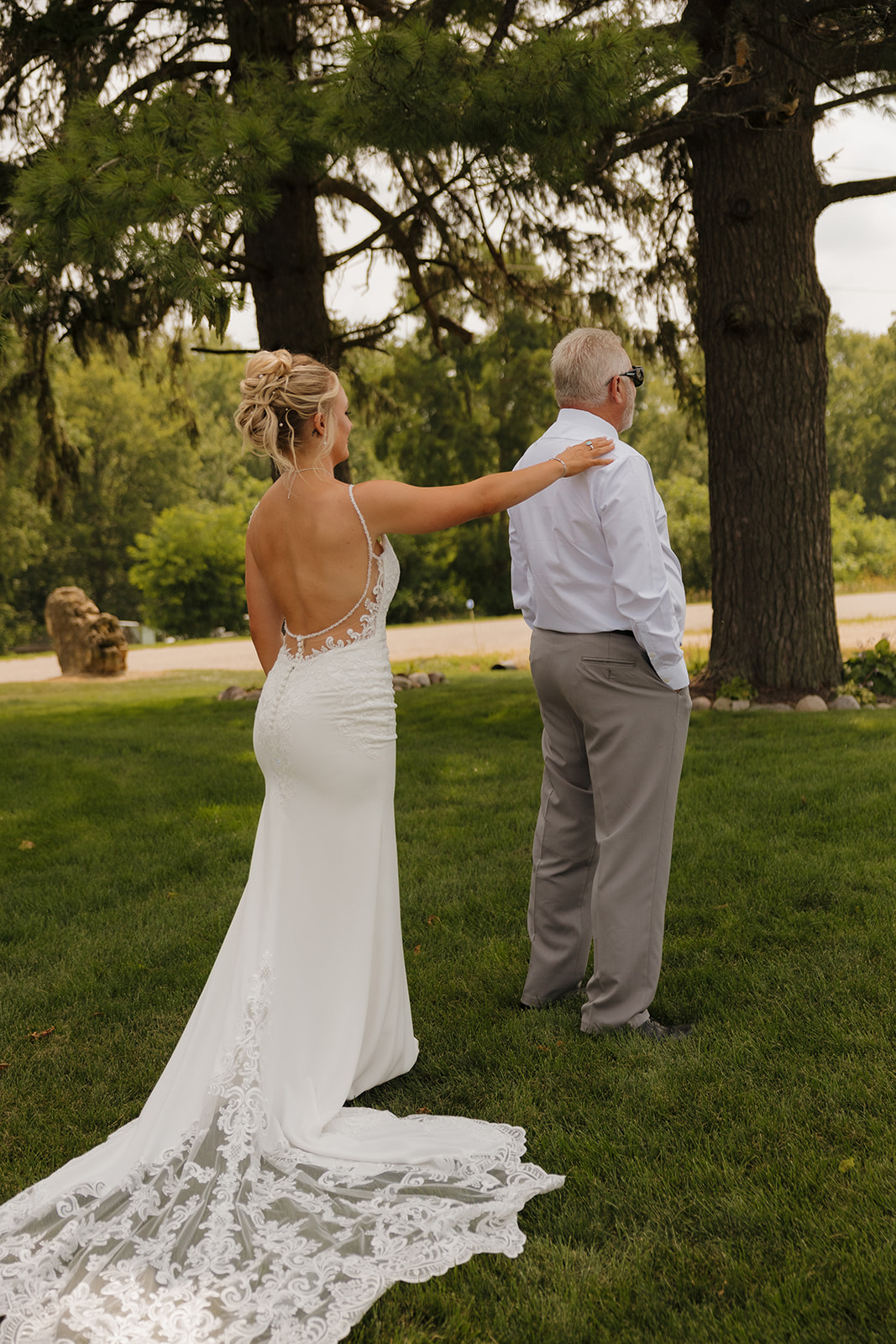 Bride about to tap her dad on the shoulder during their emotional first look.