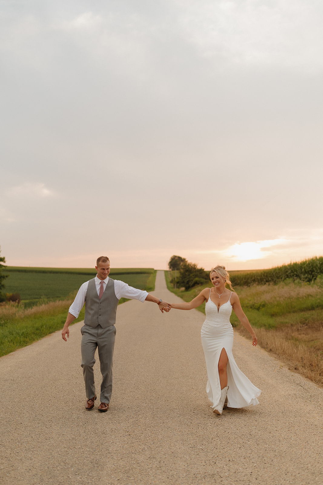 Playful couple walk toward the camera with big smiles at sunset—ideal for your wedding photography checklist inspiration.