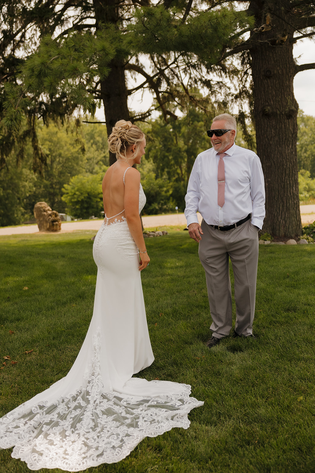 Father of the bride reacting with a big smile during their outdoor first look moment.