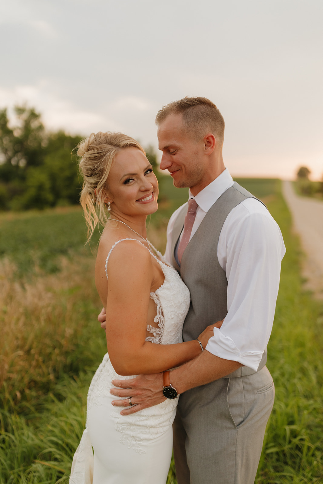 Romantic sunset portrait of the couple wrapped in each other’s arms—an essential shot for your wedding photography checklist.