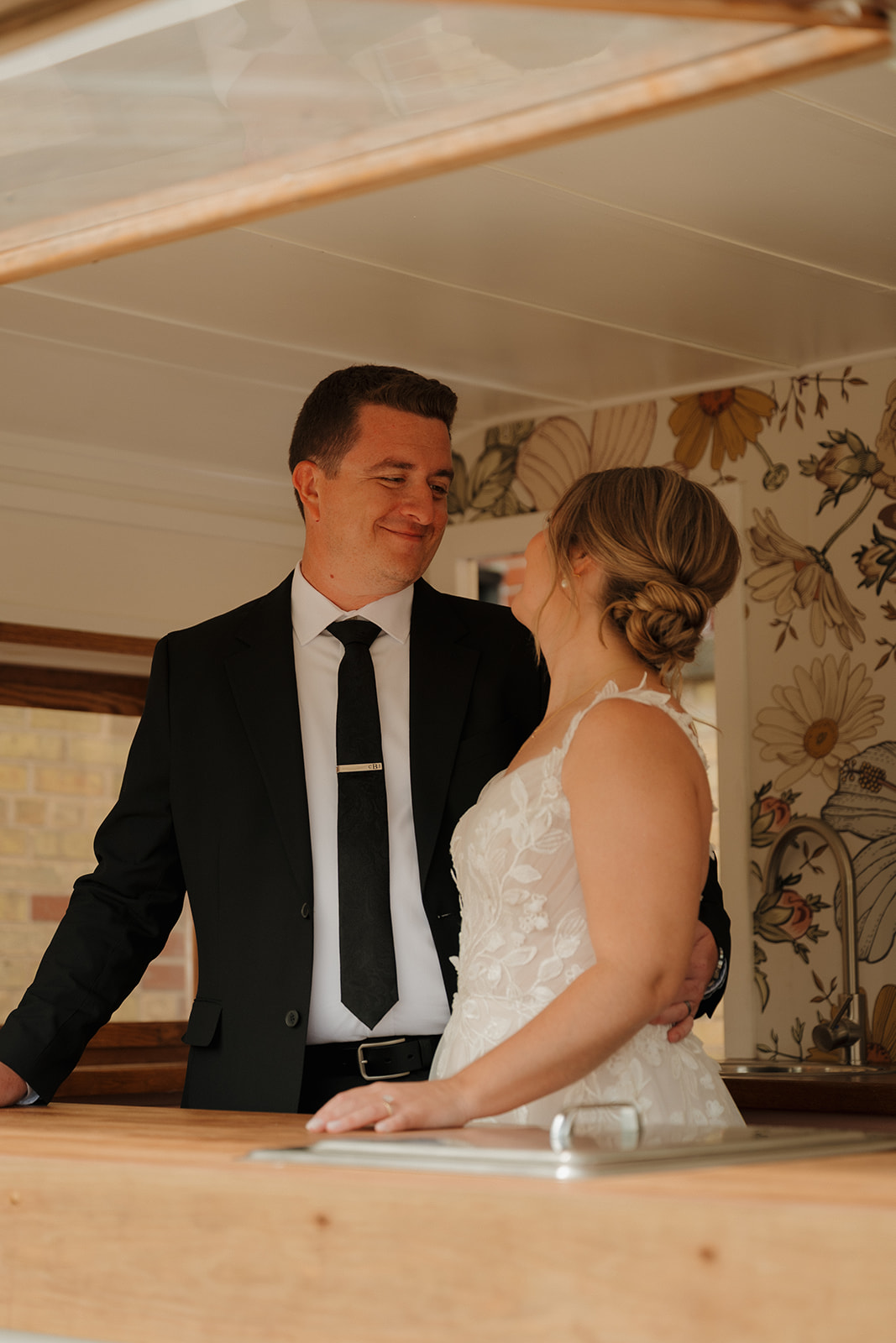 Bride and groom sharing a quiet moment together during wedding portraits indoors