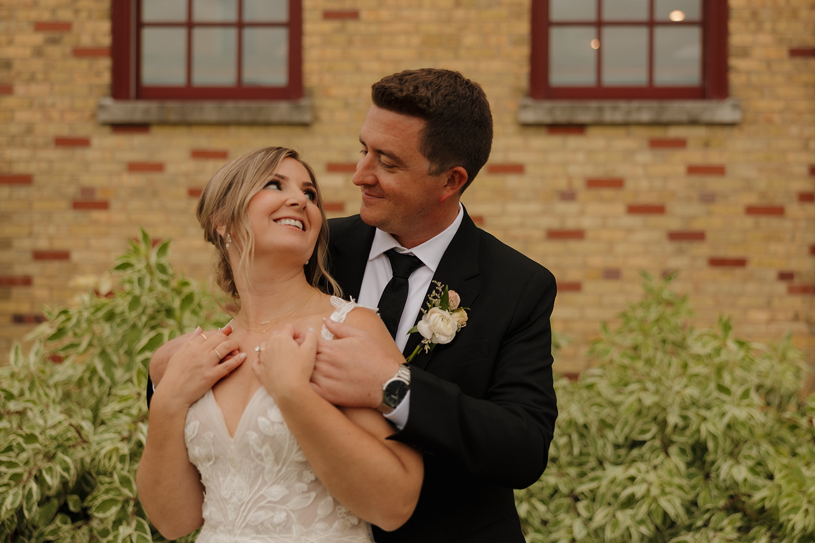Bride and groom sharing a quiet moment outside a historic brick wedding venue in Fort Myers