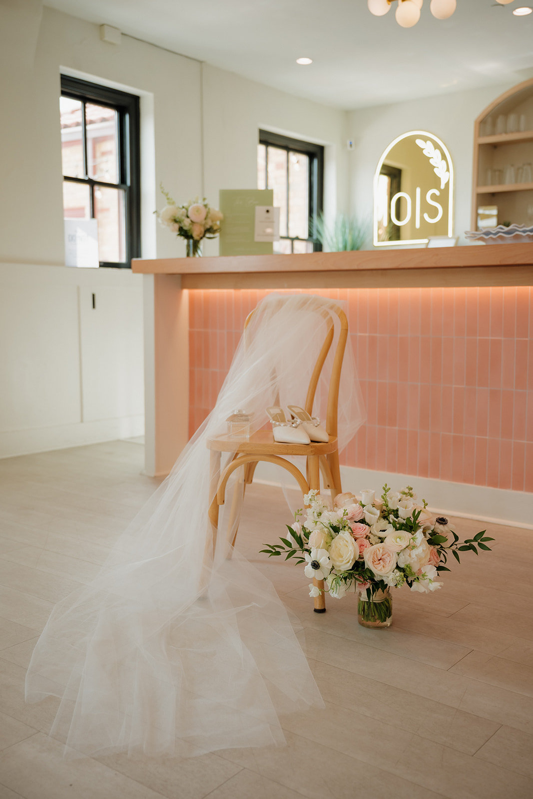 Bridal veil, shoes, and bouquet styled inside a modern wedding venue in Fort Myers Florida