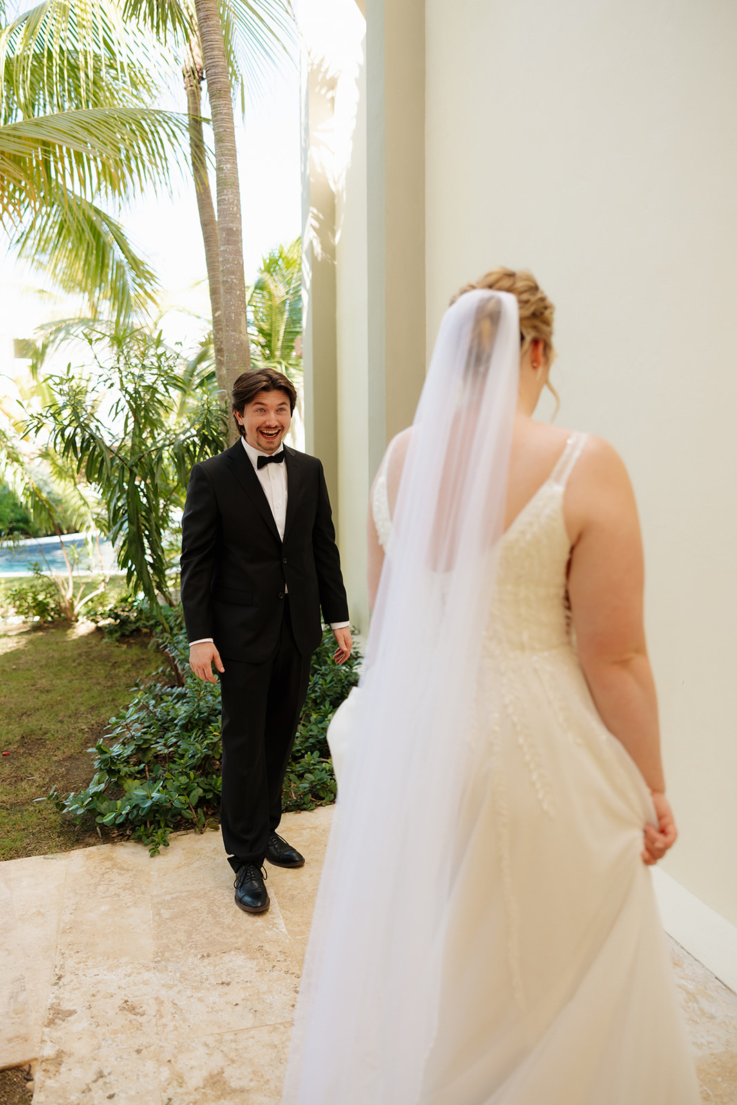 Groom’s joyful reaction during a first look with his bride at a tropical wedding venue in Fort Myers.