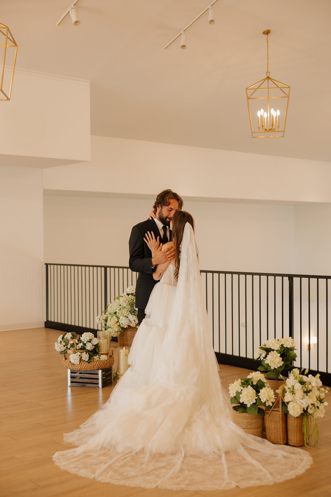 Bride and groom embracing during portraits inside a bright modern wedding venue in Fort Myers Florida