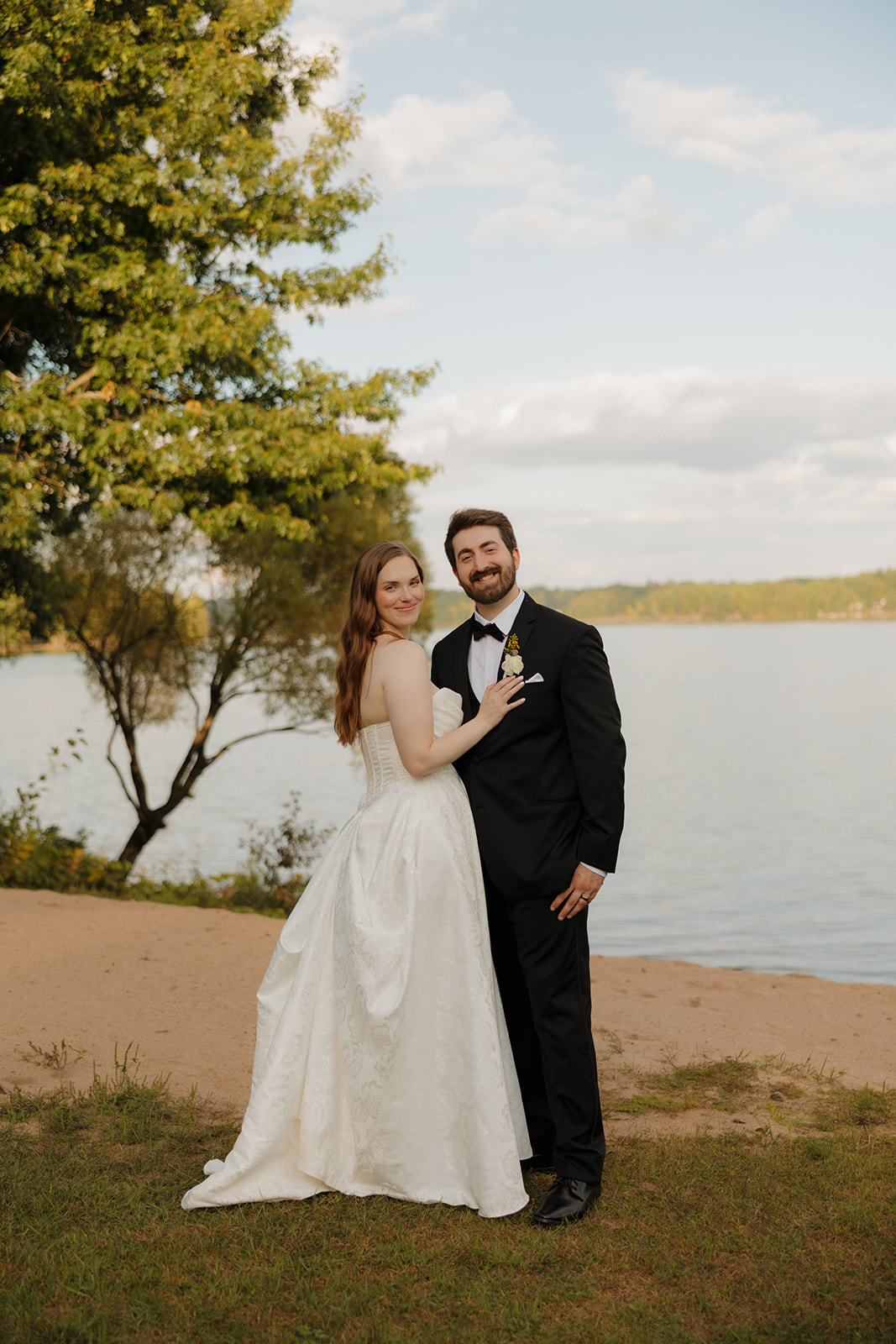 Bride and groom portrait by the water during a romantic lakeside wedding portrait session