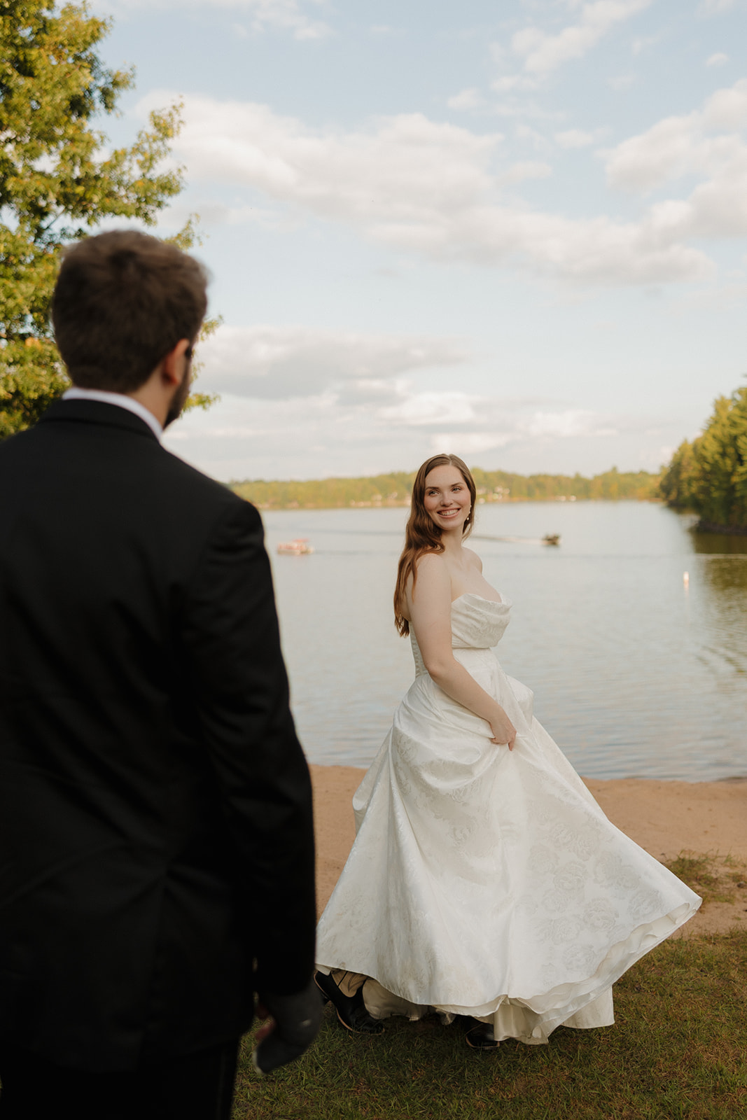 Bride twirling by the water during sunset portraits at a scenic outdoor wedding venue in Fort Myers