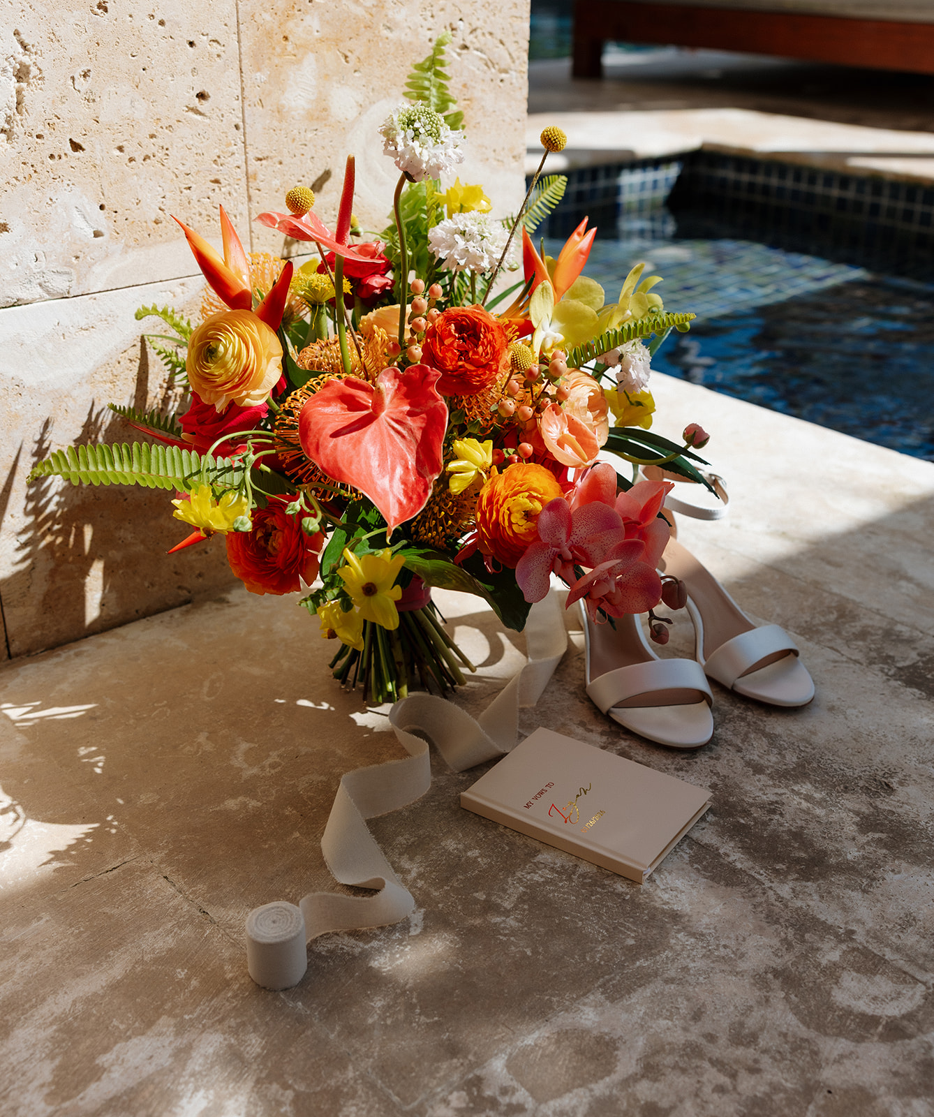 Bright tropical wedding bouquet and bridal accessories photographed by a Florida wedding photographer
