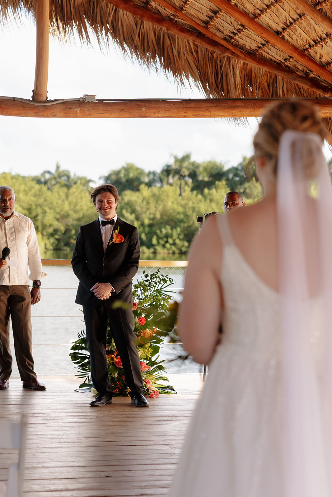 Bride walking down the aisle toward groom during a waterfront wedding in Florida