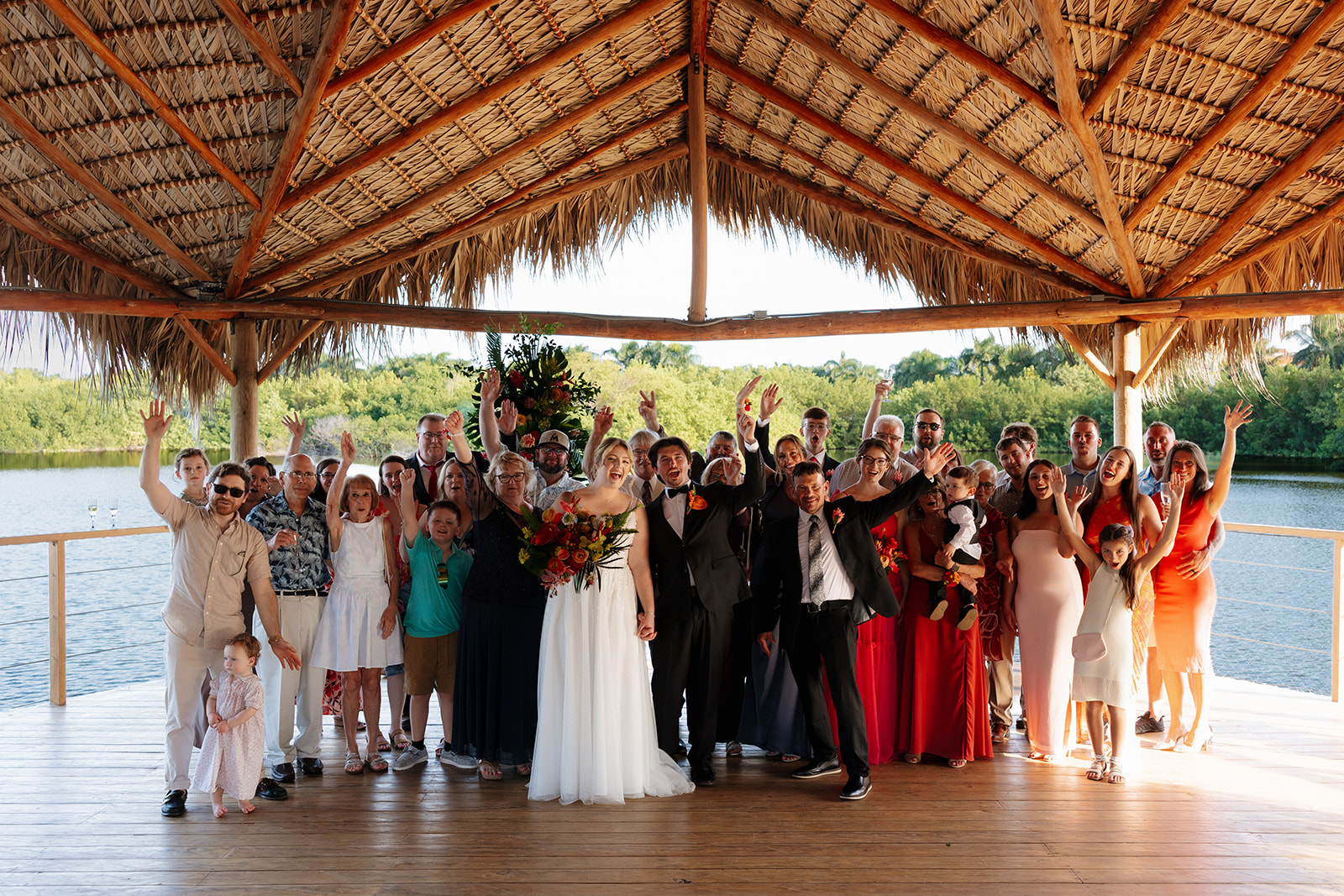 Large joyful group photo with wedding guests celebrating during a wedding in Florida
