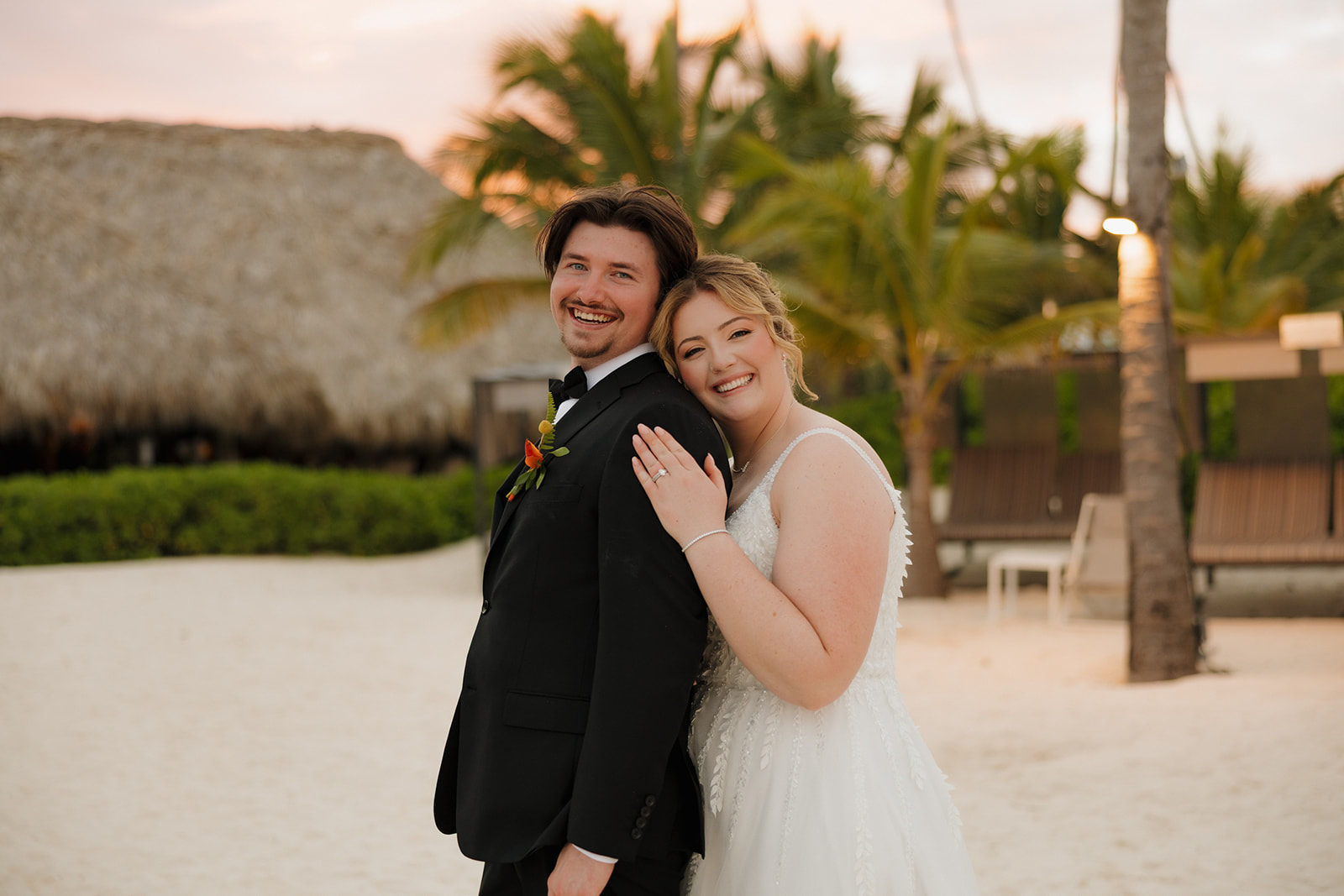 Newlyweds smiling together during golden hour portraits after their wedding in Florida
