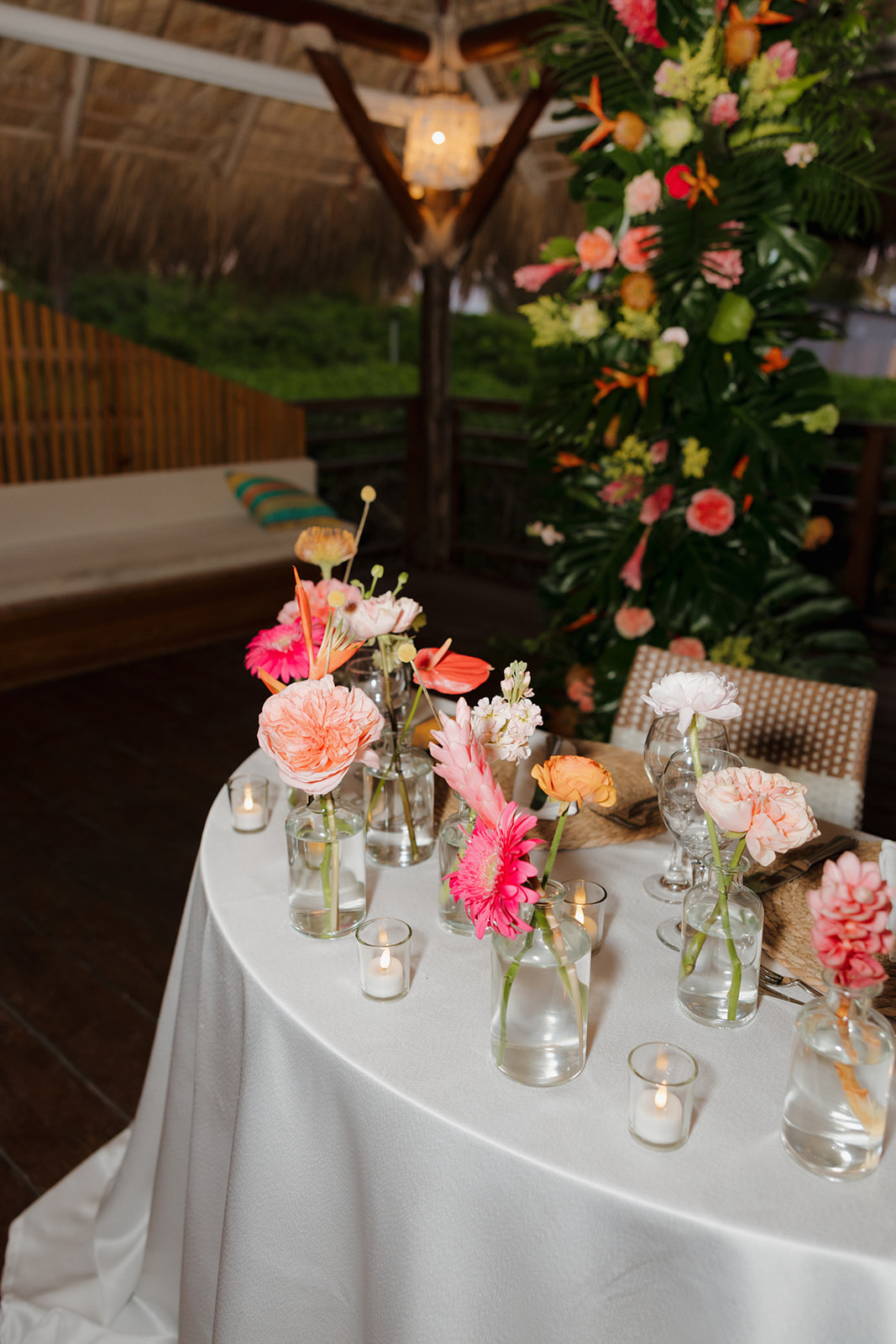 Floral reception table with tropical blooms and candlelight at a wedding in Florida
