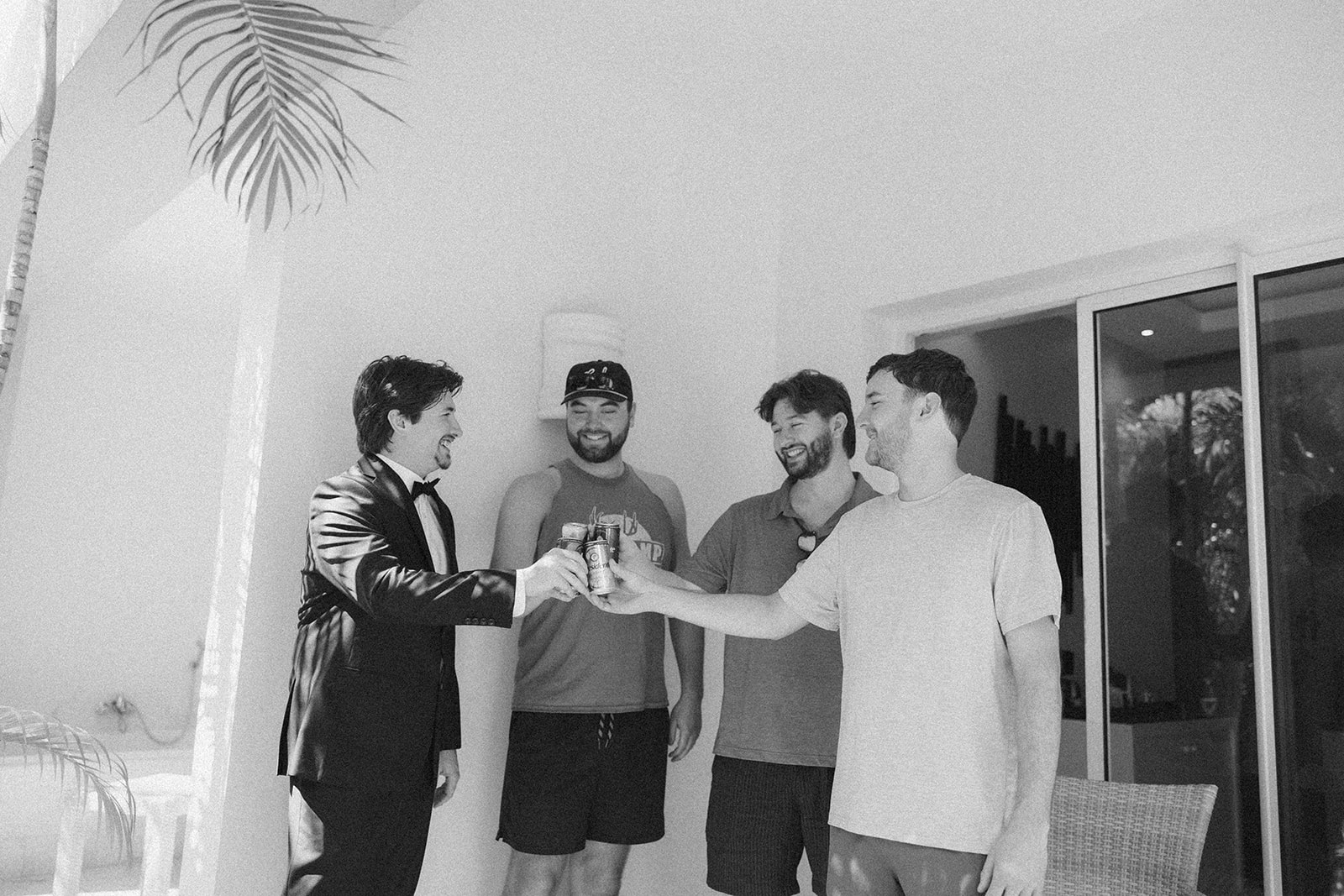 Groom celebrating with groomsmen while getting ready for a wedding in Florida
