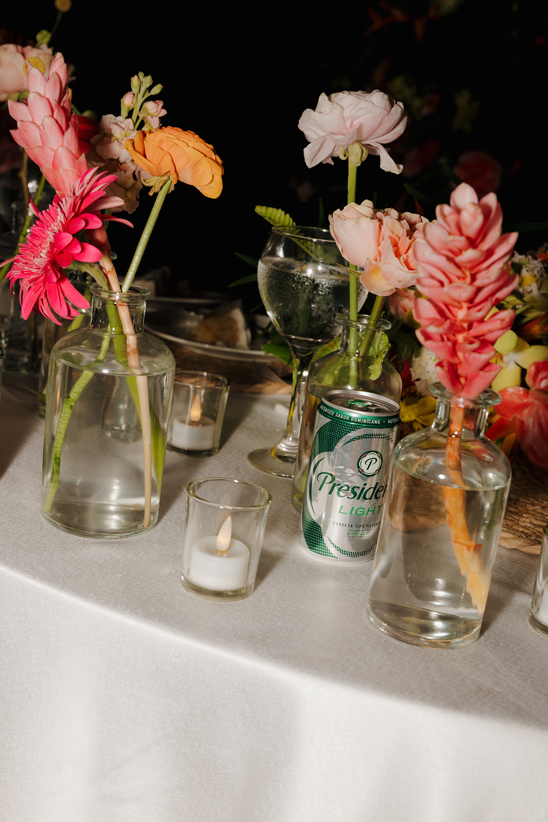 Colorful tropical wedding centerpieces with candles and flowers during a wedding reception in Florida
